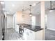 Kitchen featuring modern black marbled countertops, stainless appliances, and stylish pendant lighting at 780 Corral Dr, Charleston, SC 29414
