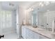 Well-lit bathroom with double sinks, granite countertops, and a large mirror at 825 Marsh Grove Ave, Mount Pleasant, SC 29464