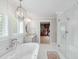 Spacious bathroom showcasing a soaking tub, large vanity, walk-in shower, and closet access at 825 Marsh Grove Ave, Mount Pleasant, SC 29464