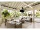 Cozy covered patio with wicker furniture, ceiling fans, and serene outdoor views at 825 Marsh Grove Ave, Mount Pleasant, SC 29464