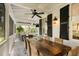 Covered patio with a rustic wood table, wicker chairs, ceiling fan, and outdoor lighting at 825 Marsh Grove Ave, Mount Pleasant, SC 29464
