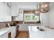 Gourmet kitchen with white cabinets, brick backsplash, designer lighting, and professional grade appliances at 825 Marsh Grove Ave, Mount Pleasant, SC 29464