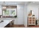 Well-lit kitchen with custom cabinets, farmhouse sink, and modern appliances, perfect for cooking at 825 Marsh Grove Ave, Mount Pleasant, SC 29464