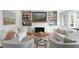 Bright living room features white shiplap walls, built-in shelving, and comfortable seating around a round coffee table at 825 Marsh Grove Ave, Mount Pleasant, SC 29464