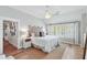 Main bedroom with wood-look floors, bright windows, and ensuite bathroom access at 825 Marsh Grove Ave, Mount Pleasant, SC 29464