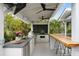 Well-equipped outdoor kitchen with a stainless steel grill, a green egg grill, and bar seating at 825 Marsh Grove Ave, Mount Pleasant, SC 29464