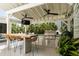 Outdoor kitchen with stainless steel grill, beverage fridge, and a bar with seating under a covered patio at 825 Marsh Grove Ave, Mount Pleasant, SC 29464
