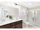 Bathroom with double vanity, framed mirror and shower at 1008 Drakeford St # 4P, Saint George, SC 29477