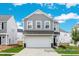 Charming two-story home with gray siding, a two-car garage, and a well-manicured lawn on a sunny day at 1008 Drakeford St # 4P, Saint George, SC 29477