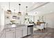 Open-concept kitchen with granite island, pendant lights, seamlessly flowing into the living area at 1008 Drakeford St # 4P, Saint George, SC 29477