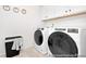 Well-equipped laundry room featuring modern washer and dryer, white cabinets, and stylish decor at 1008 Drakeford St # 4P, Saint George, SC 29477