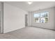 Spacious bedroom with ample natural light from two windows with view and neutral walls at 1017 Marsh Harrier Dr # Cc3-3-3, Ravenel, SC 29470
