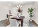 Dining room features a dark wood table, six chairs, modern chandelier, and wood-look flooring at 1017 Marsh Harrier Dr # Cc3-3-3, Ravenel, SC 29470