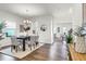 Light-filled dining room features a wooden table, comfortable seating, and stylish decor at 1017 Marsh Harrier Dr # Cc3-3-3, Ravenel, SC 29470