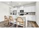Bright kitchen with stainless steel appliances, white cabinets, marble countertops, and a three seat kitchen island at 1017 Marsh Harrier Dr # Cc3-3-3, Ravenel, SC 29470