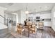 Open concept kitchen with white cabinets, stainless steel appliances, and dining area, perfect for entertaining at 1017 Marsh Harrier Dr # Cc3-3-3, Ravenel, SC 29470
