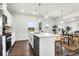 Bright kitchen features white cabinets, stainless steel appliances, and a center island with bar seating at 1017 Marsh Harrier Dr # Cc3-3-3, Ravenel, SC 29470