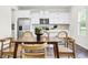 Modern kitchen featuring white cabinets, stainless steel appliances, island seating, and stylish pendant lights at 1017 Marsh Harrier Dr # Cc3-3-3, Ravenel, SC 29470