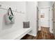 Mudroom with bench seating, coat hooks, wood-look flooring, and neutral color palette at 1017 Marsh Harrier Dr # Cc3-3-3, Ravenel, SC 29470