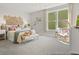 A cozy bedroom featuring neutral tones, a decorative headboard, and lots of natural light at 1018 House Finch Ave # Cc3-22-8, Ravenel, SC 29470