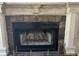 Close-up of a fireplace with a decorative tile surround, mantel and hearth at 1026 Stono River Dr, Charleston, SC 29412