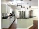 Modern kitchen with white cabinetry, black countertops, stainless steel appliances, and bar seating at 1026 Stono River Dr, Charleston, SC 29412