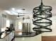 Close-up of modern pendant lighting in a kitchen with stainless appliances and dark countertops at 1026 Stono River Dr, Charleston, SC 29412