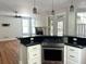 Bright, open kitchen with stainless steel appliances, granite countertops and view into living room at 1026 Stono River Dr, Charleston, SC 29412