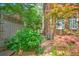 Brick walkway along house and fence with lush landscaping and greenery. A perfect, intimate outdoor space for relaxing at 1026 Stono River Dr, Charleston, SC 29412