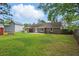 Spacious backyard featuring a brick house, patio area, and well-maintained lawn, perfect for outdoor activities at 106 Ruffin Rd, Summerville, SC 29486