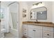 Renovated bathroom with granite countertop vanity and combination tub and shower at 106 Ruffin Rd, Summerville, SC 29486