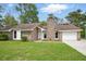 Charming one-story brick home featuring a well-maintained lawn and attached garage under a bright sky at 106 Ruffin Rd, Summerville, SC 29486