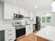 Modern kitchen featuring white cabinets, stainless appliances, island, and quartz countertops at 106 Ruffin Rd, Summerville, SC 29486