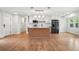 Updated kitchen featuring white cabinets, stainless appliances, a kitchen island and vinyl wood floors at 106 Ruffin Rd, Summerville, SC 29486