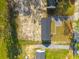 An aerial view of a home featuring a manicured lawn, and detached garage at 117 Dotson St, Harleyville, SC 29448