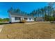 An exterior view of a charming white home with black shutters and covered deck at 117 Dotson St, Harleyville, SC 29448