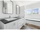 Bright bathroom featuring double sinks, cabinets and large windows at 117 Dotson St, Harleyville, SC 29448