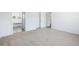 Bright carpeted bedroom featuring a closet, and a door to another room at 117 Dotson St, Harleyville, SC 29448