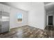 Bright dining area featuring wood flooring, a large window, and stainless steel refrigerator at 117 Dotson St, Harleyville, SC 29448