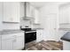 Kitchen featuring modern appliances, subway tile backsplash, white cabinetry and countertops at 117 Dotson St, Harleyville, SC 29448