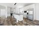Modern kitchen with stainless steel appliances, a central island, and stylish white cabinetry at 117 Dotson St, Harleyville, SC 29448