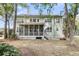 Spacious backyard with screened porch, fire pit, and green lawn at 1185 Out Of Bounds Dr, Summerville, SC 29485