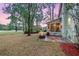 Inviting backyard with a cozy fire pit and screened-in porch at 1185 Out Of Bounds Dr, Summerville, SC 29485