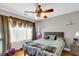 Comfortable bedroom with a striking ceiling fan, complemented by soft lighting and inviting decor at 1185 Out Of Bounds Dr, Summerville, SC 29485