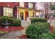 Inviting brick home with a covered front porch, white columns, and lush landscaping at 1185 Out Of Bounds Dr, Summerville, SC 29485
