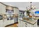 Bright kitchen with stainless steel appliances, island with bar seating, and backyard views at 1185 Out Of Bounds Dr, Summerville, SC 29485