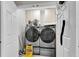 Modern laundry room features front-load washer and dryer and cabinet storage at 1185 Out Of Bounds Dr, Summerville, SC 29485