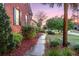 Beautifully landscaped side yard with a winding pathway and lush greenery at 1185 Out Of Bounds Dr, Summerville, SC 29485