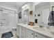 Bathroom featuring dual vanity, tub with shower, and neutral decor at 119 Loon Dr, Summerville, SC 29483