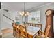 Bright dining room featuring a large wooden table, elegant chandelier, and ample natural light at 119 Loon Dr, Summerville, SC 29483